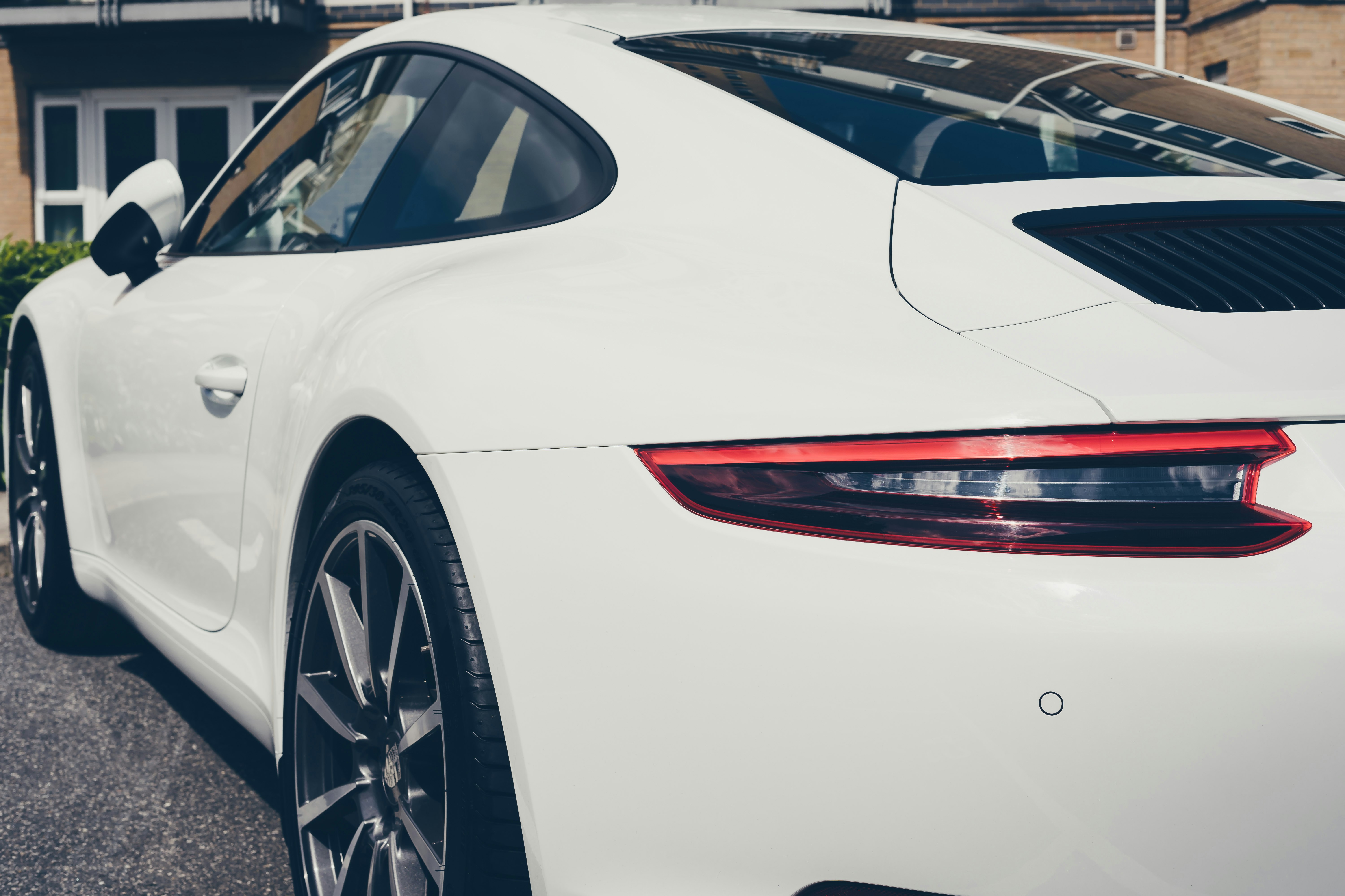 white porsche 911 parked on parking lot